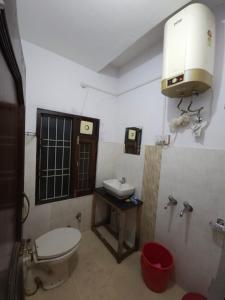 a bathroom with a toilet and a sink at JMC Homestay in Kukri Ser
