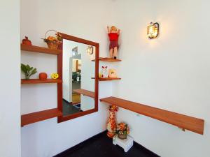 a room with wooden shelves and a mirror on the wall at Yokel View Villa in Weligama +73 photos