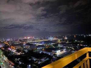 a view of a city at night with lights at Coast Residences Zeus Place in Manila +12 photos