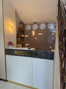 an office with clocks on the wall and a reception counter at Podshoh guest house in Samarkand