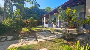 a garden with some plants and a house at Casa de Granja-Praia de Cotovelo in Parnamirim