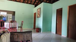a living room with a table and a couch in it at Casa de Granja-Praia de Cotovelo in Parnamirim +12 photos