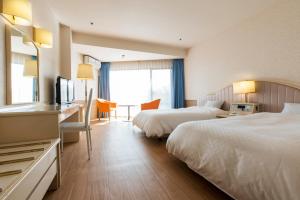 Ένα ή περισσότερα κρεβάτια σε δωμάτιο στο Izu-Kogen Wan Wan Paradise Hotel & Cottage