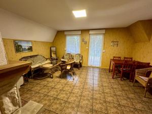 a living room with a couch and a table and chairs at Domek Letniskowy Głebinów in Nysa