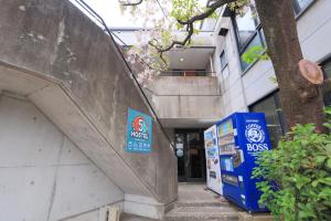 a building with a sign on the side of it at Hostel FIVE ホステルファイブ in Kochi