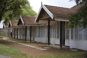 a row of houses with white windows and roofs at The Tredis Heritage by the Lake in Kodaikānāl