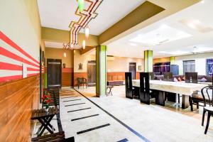 a large lobby with a large table and chairs at Super Collection O Behala in Kolkata
