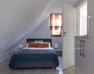a white bedroom with a bed and a window at Nadmorska Osada in Łeba +54 photos