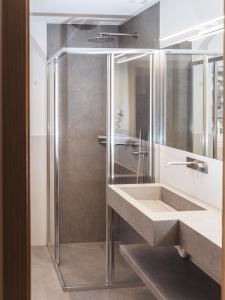 a bathroom with a sink and a shower at Paradeis Apartments A19 in Mühlbach
