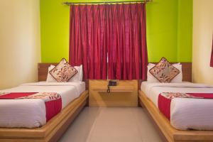 Postel nebo postele na pokoji v ubytování Hotel O Gitanjali Inn
