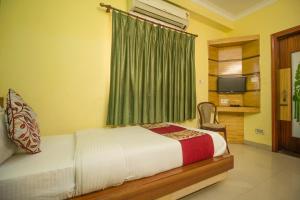 Postel nebo postele na pokoji v ubytování Hotel O Gitanjali Inn