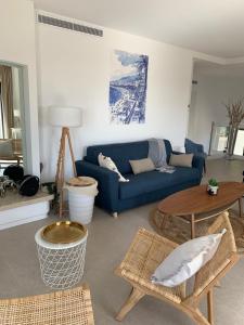 a living room with a blue couch and a table at Superbe Villa - 3 appartements distinct - 20 couchages in Cagnes-sur-Mer +26 photos