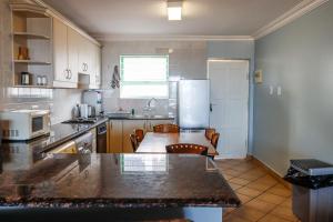 a kitchen with a counter top and a refrigerator at Lemnos 14 in Margate +7 photos