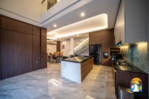 a large kitchen with a island in a room at Villa Blissful - by Unicorn Villas Bali in Nusa Dua
