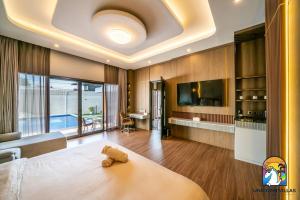 a bedroom with a bed and a living room at Villa Blissful - by Unicorn Villas Bali in Nusa Dua +41 photos