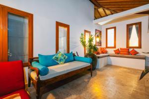 a living room with a couch with blue pillows at Villa Moringa 2 - Private Villa in the Heart of Canggu, 5 Minutes from the Beach in Canggu +58 photos
