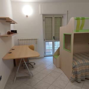 a bedroom with a desk and a bed and a table at La Piccola Valle in Vallefiorita
