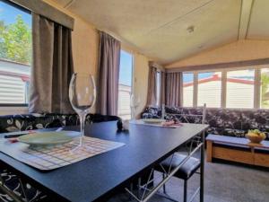 a living room with a table with a wine glass at I love Costinesti in Costinesti