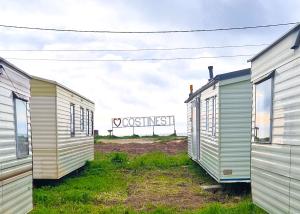 a row of houses in a field with a noossessing sign at I love Costinesti in Costinesti