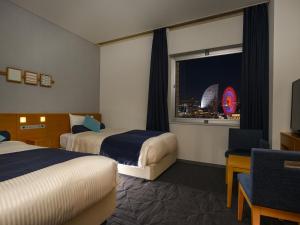 Postel nebo postele na pokoji v ubytování Yokohama Sakuragicho Washington Hotel