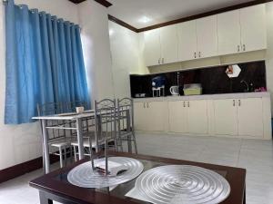 a kitchen with a table and chairs and a dining room at M and M Apartment in Surigao