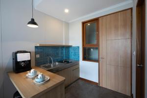 a kitchen with a counter with a sink and a counter sidx sidx sidx at Atania Apartment in Jimbaran