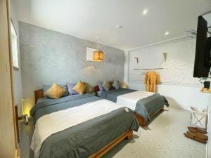 a bedroom with two beds and a flat screen tv at VV House Quy Nhon in Quy Nhon +91 photos