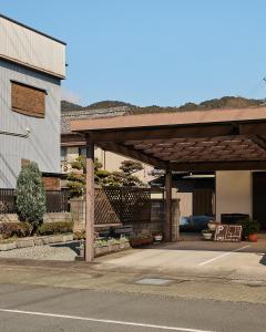 a building with a pavilion on the side of a road at 民泊あまやど Amayado in Owase