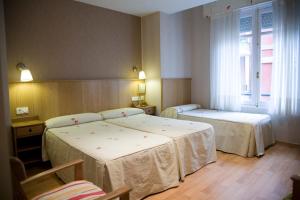 Postel nebo postele na pokoji v ubytování Hostal Orejas