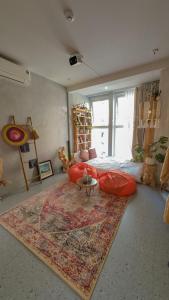 a living room with a couch and a table on a rug at VV House Quy Nhon in Quy Nhon