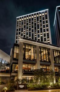 a tall building with lights on in front of it at Hilton Yokohama in Yokohama