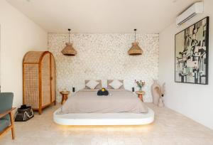 a bedroom with a large bed in a room at Karma House Ungasan in Jimbaran
