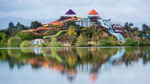 a water park with a roller coaster on a hill next to a lake at Views on the Hill in San Jose