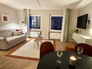 a living room with a couch and a table at Westflügel Apartment mit Parkplatz und zentraler Lage in Bad Rothenfelde