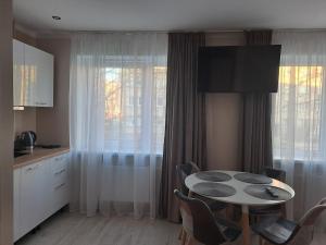 a kitchen with a table and chairs in a room at Sun 2 in Rēzekne