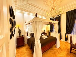 a bedroom with a bed with a canopy at 7th HEAVEN Vienna Center Apartments in Vienna
