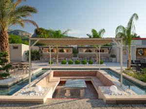 a villa with a swimming pool and a house at Monk Resort Hotel Beldibi in Kemer