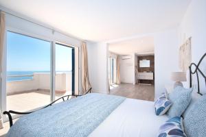 a bedroom with a bed with a view of the ocean at Domus Alba A in Portocolom +57 photos