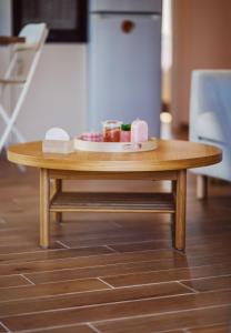 a wooden coffee table with a plate of food on it at K&E Guesthouse in Preveza