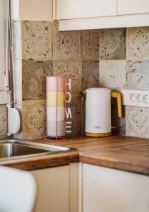 a kitchen counter top with a coffee pot on it at K&E Guesthouse in Preveza