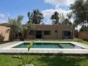 a house with a swimming pool in the yard at Villa JADE with private pool only family in Marrakech +38 photos