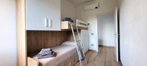 a small room with a bunk bed and a ladder at Casa Nue - Appartamento Deluxe in Posada