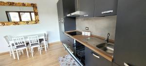a kitchen with a sink and a counter with a mirror at Casa Nue - Appartamento Deluxe in Posada