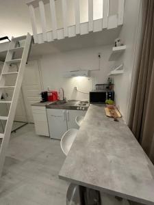 a kitchen with a large counter top in a room at Little house by the beach in Norrköping