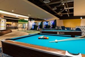 a billiard room with a pool table and balls at Beppu SUGINOI HOTEL in Beppu