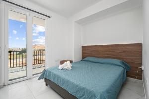 a bedroom with a bed with a stuffed animal on it at Modern 2BR Apartment Near Ayia Napa - Anastasia 104 in Xylophaghou