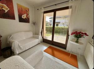 a living room with a couch and a window at VILLA CAMPAGNA in Isola Albarella