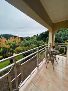 a patio with a table and chairs on a balcony at 692 Annet Drive in Durban +22 photos