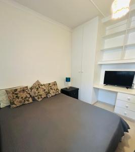 a bedroom with a bed and a tv on a shelf at 692 Annet Drive in Durban