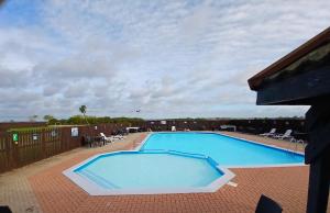 a large blue swimming pool on top of a building at Steeple Bay F79 in Steeple